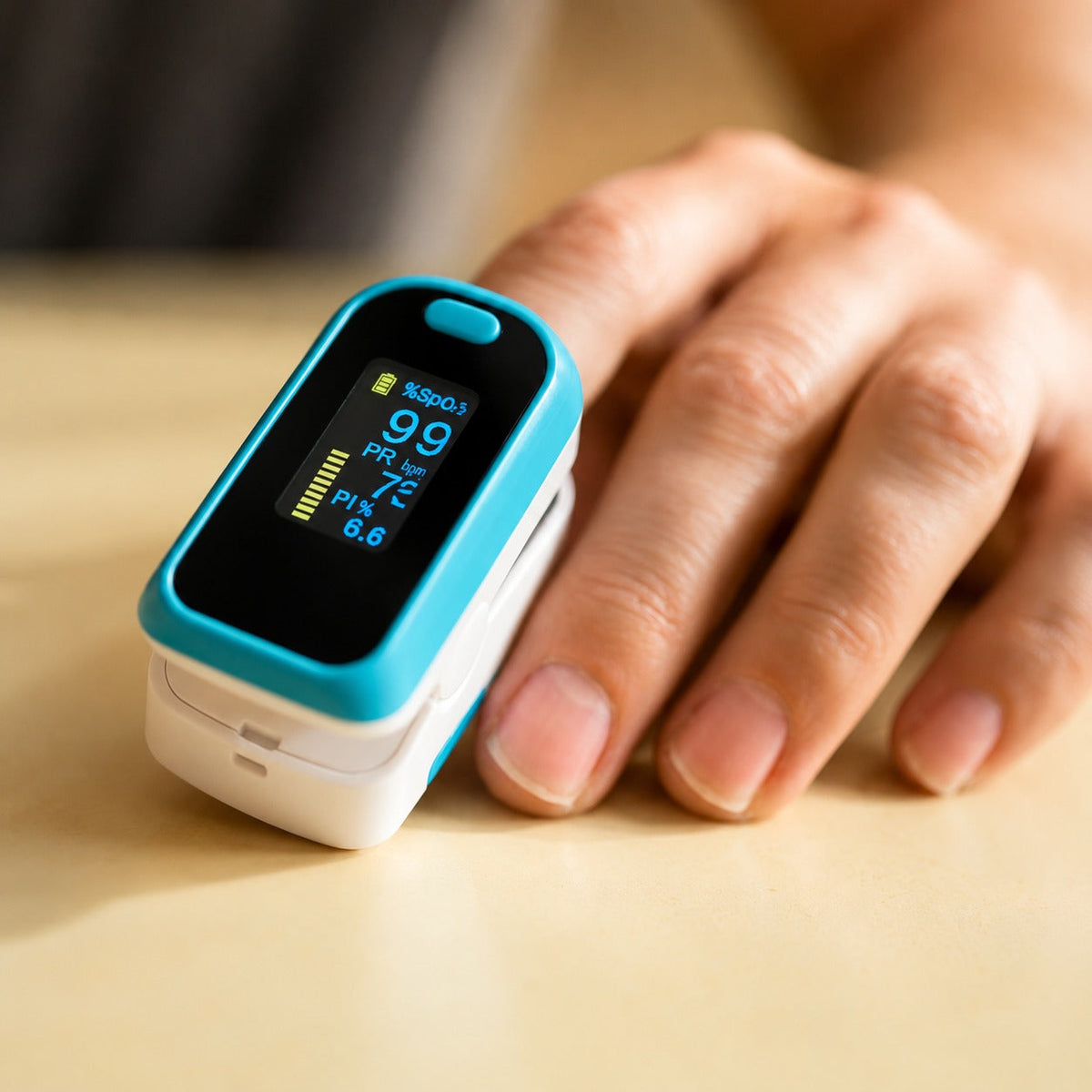 Blue fingertip pulse oximeter clipped on finger showing oxygen levels